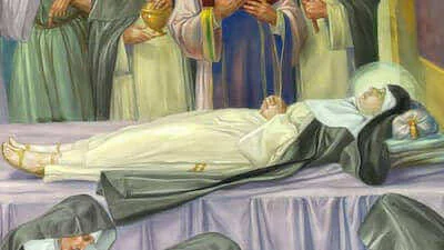 Santa Amelia expuesta en una cama funeraria